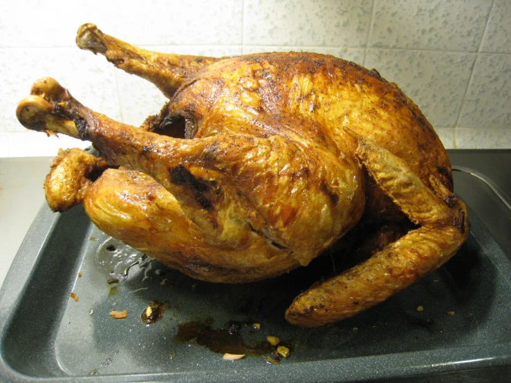 a large whole chicken is being prepared in a pan