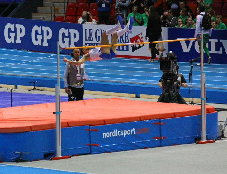 a guy standing on a track during a competition