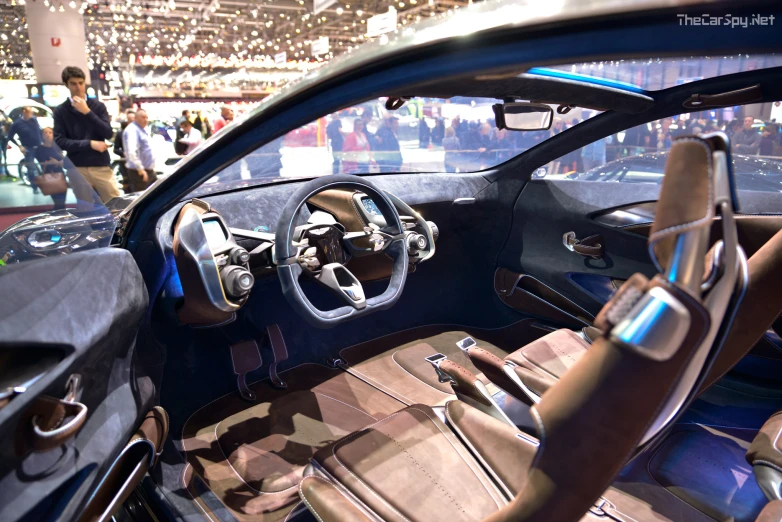 a view from the drivers perspective, showing the driver's cockpit, steering wheel, and center console area of a sports car