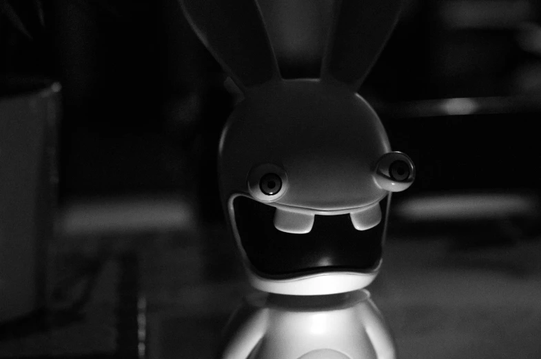 a little rabbit robot on a counter with it's face open