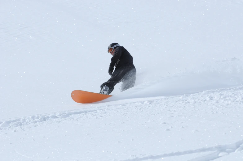snowboarder coming down from a snowy hill