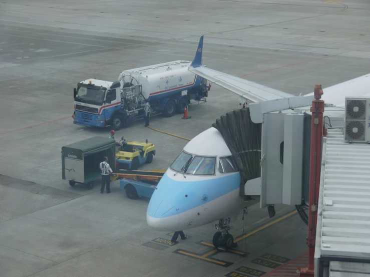 an airplane is parked next to two other planes