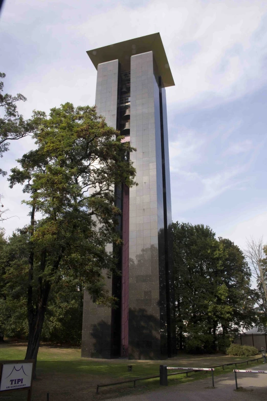 a building sitting next to a tree with a clock tower