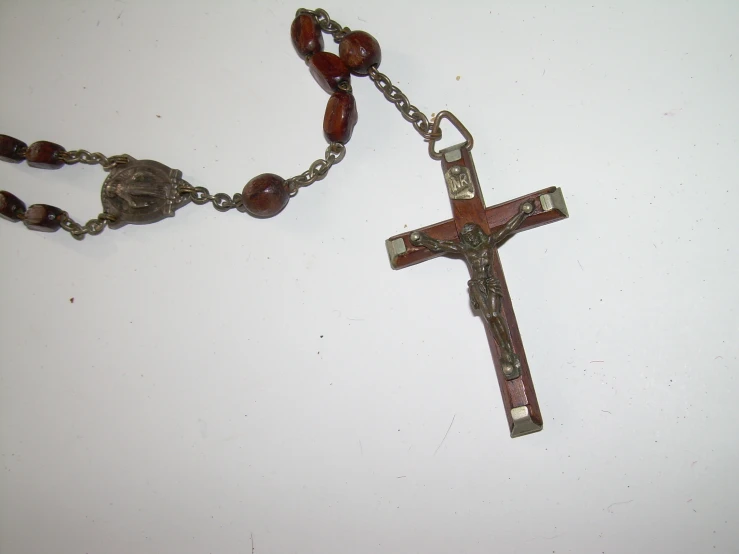 a rosary with beads on a white surface