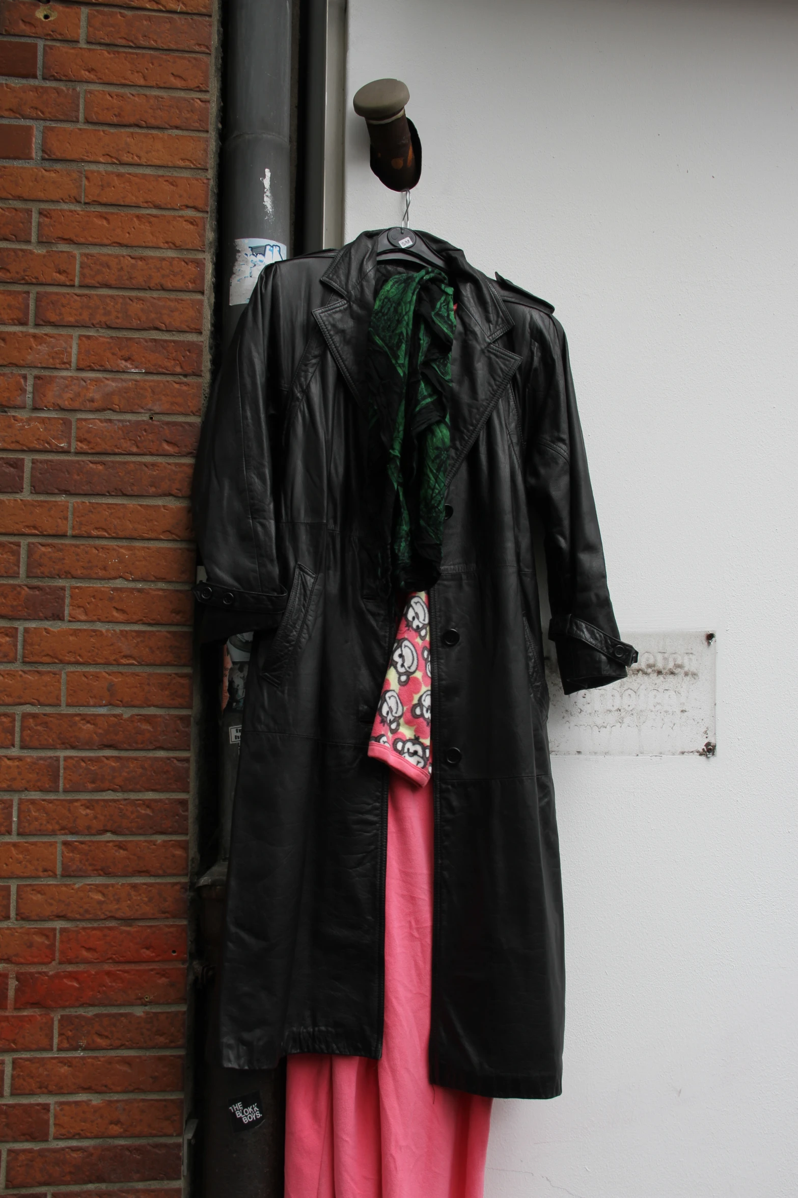 a black jacket is hanging on a pole