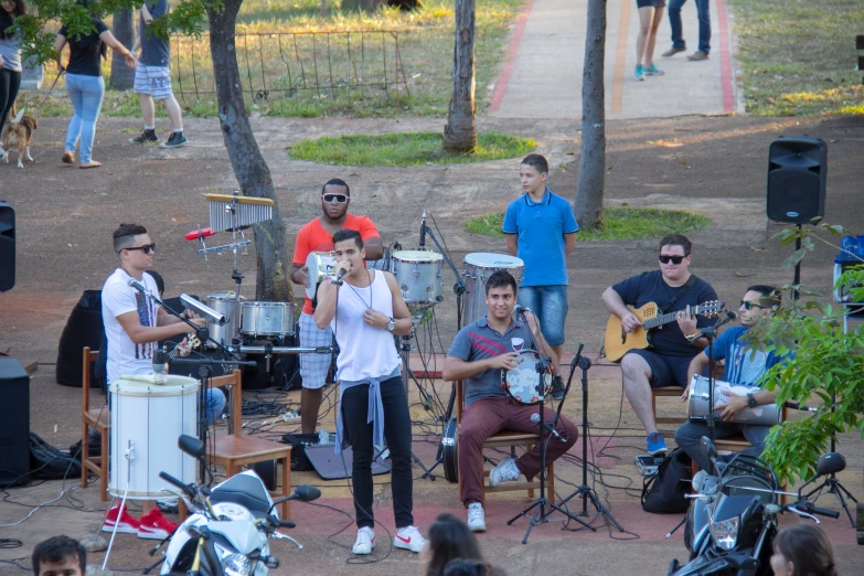 a band on stage playing music at the park