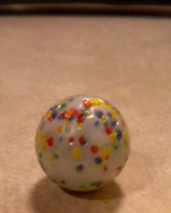an object that has been painted white with colored sprinkles