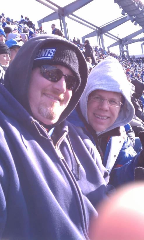 a woman and man taking a selfie at a baseball game