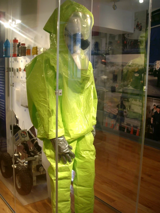 yellow plastic cover on a mannequin inside of a store