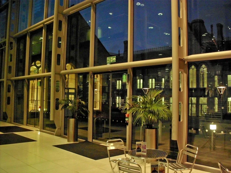 an empty patio area near large windows that are covered in sun glares