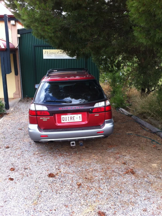 a red car sits parked in the driveway