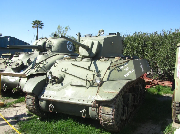 there is an old war tank in the grass