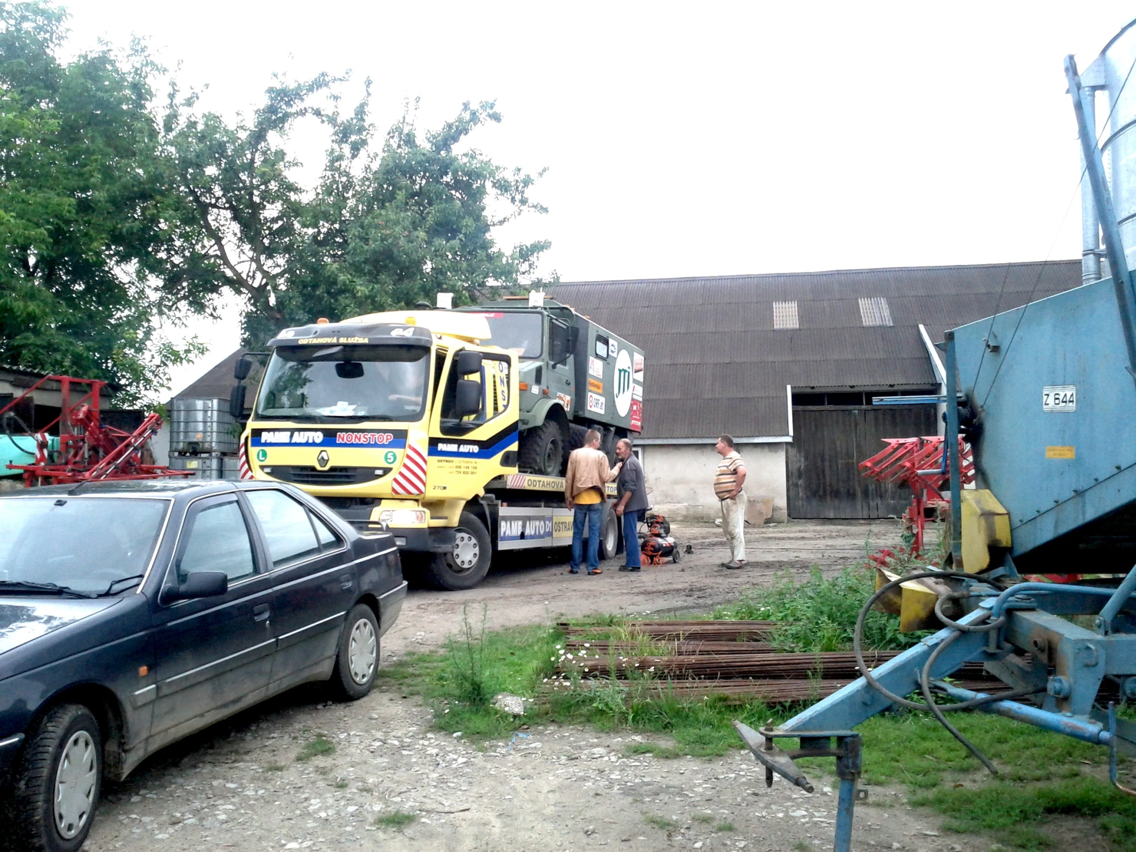 the car is pulling in on the trailer with it's door open