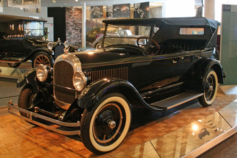 an antique model of a black car with a black roof
