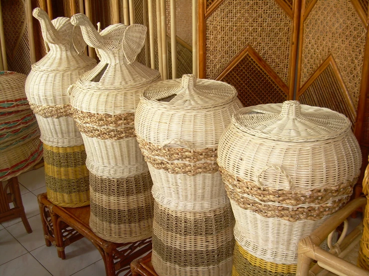 there are four decorative vases on display