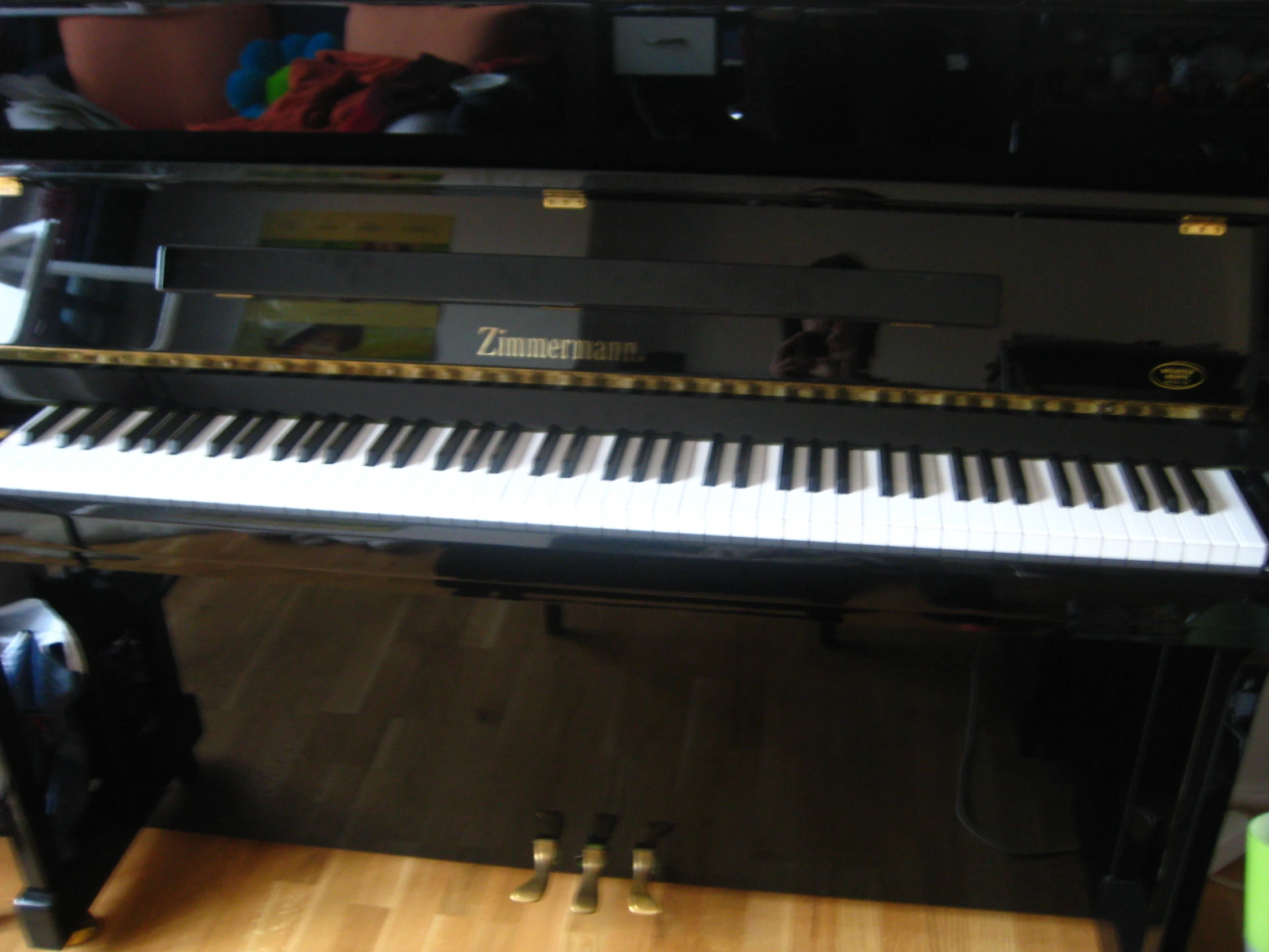 an upright piano sits in the corner of a room