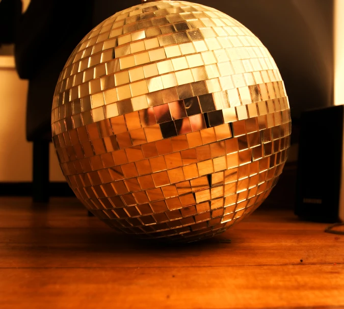 the reflection of a person's face in the mirror of a disco ball