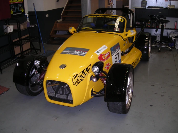 a yellow car is parked inside a garage