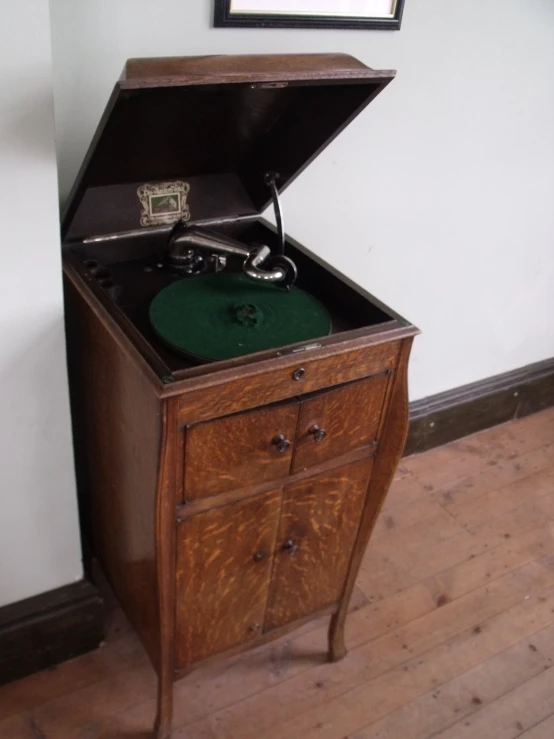 a record player in an open chest in the corner