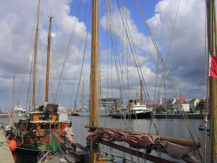 several sail boats tied to the sides of ships