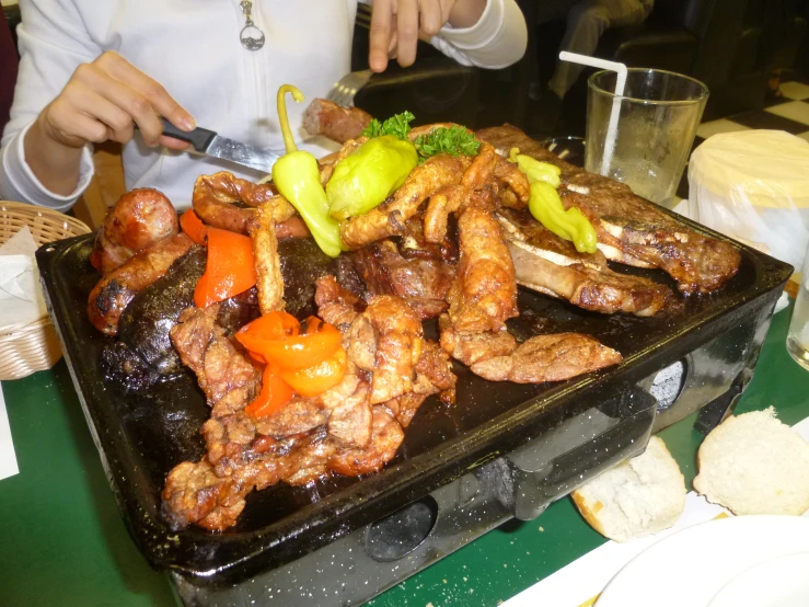 a plate topped with chicken wings, carrots and broccoli