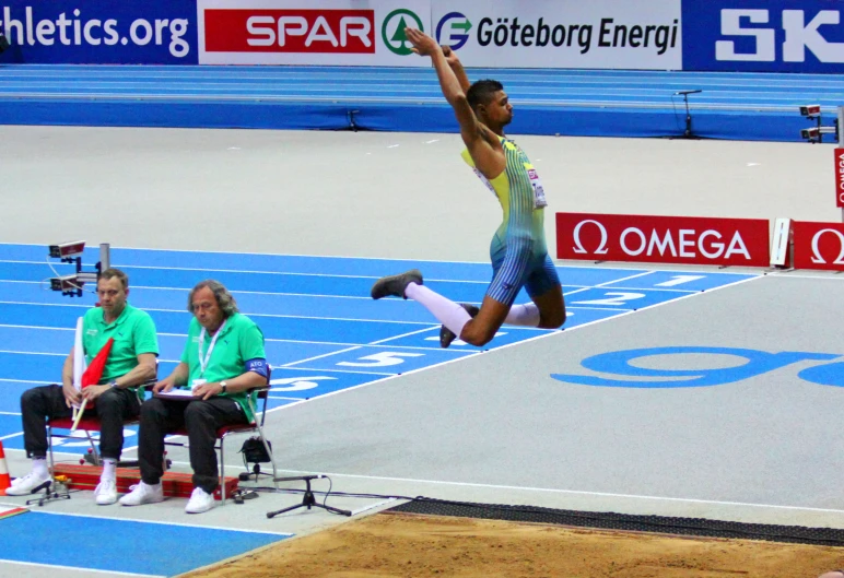 the person is jumping high in the air on the olympic race