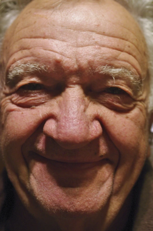 a close up of a person smiling with hair