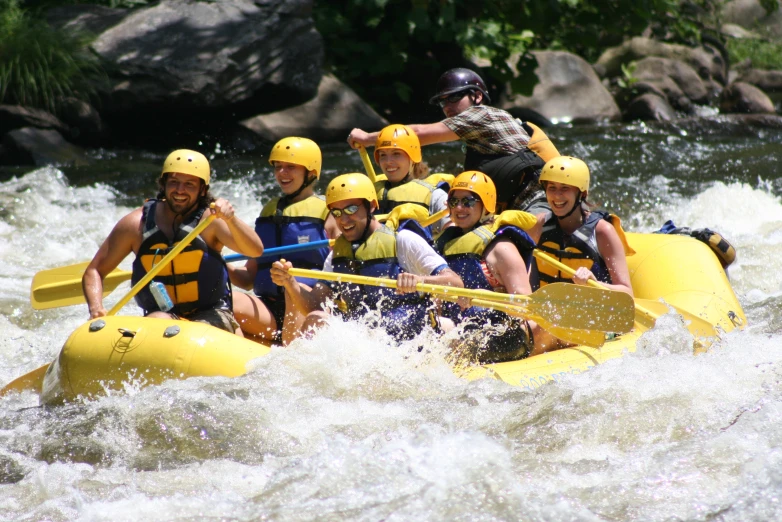 a group of people are riding in rafts