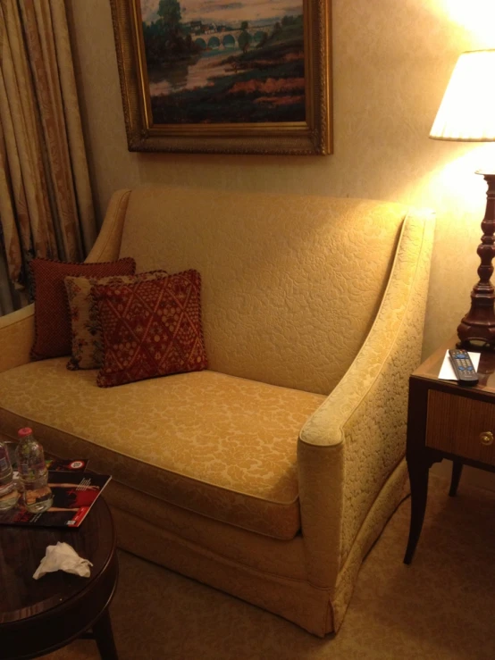 a couch in a el room next to a lamp