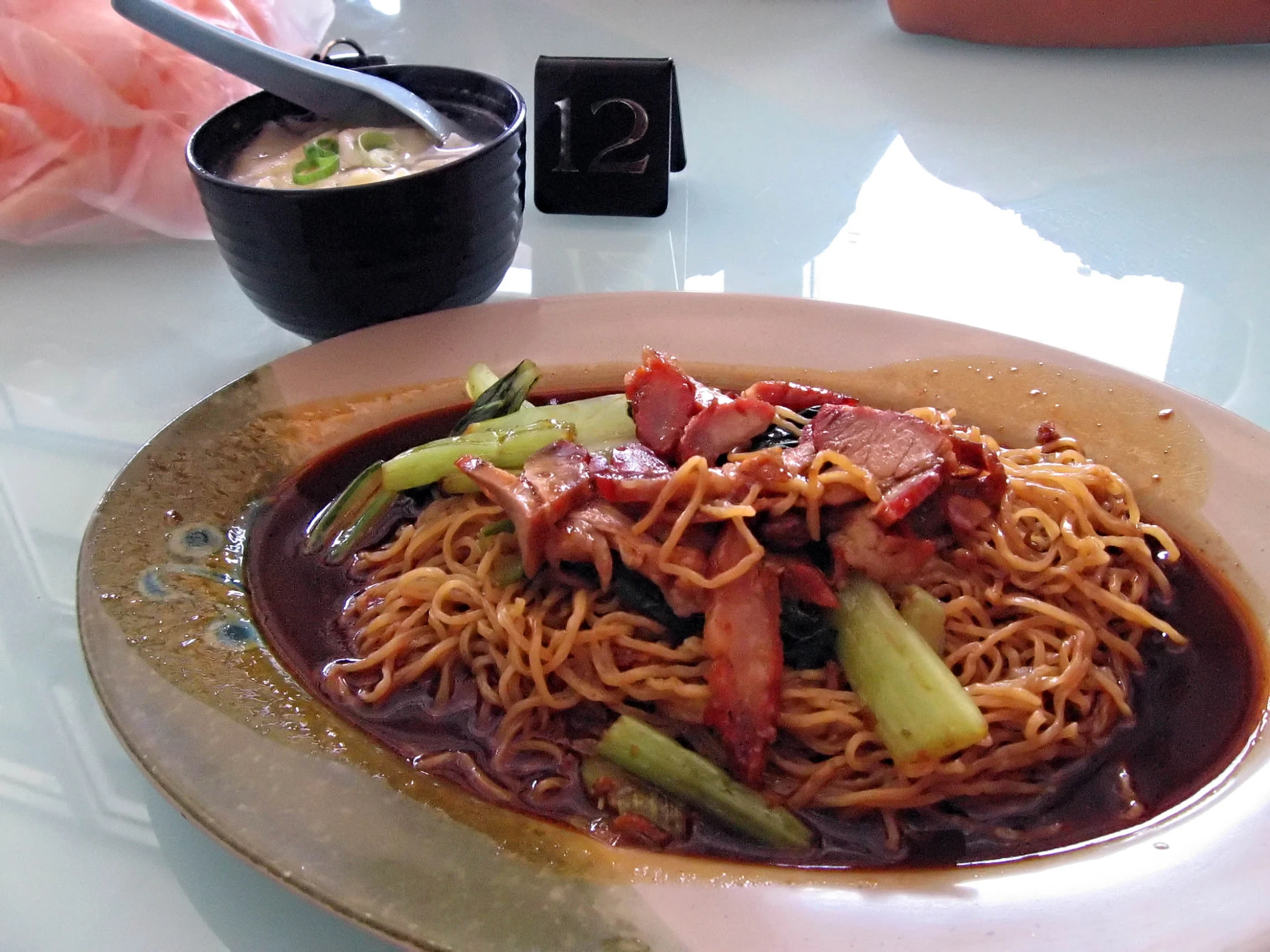 a plate with noodles and meat on it