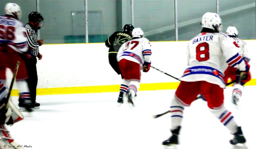 three men in white and red jerseys playing ice hockey