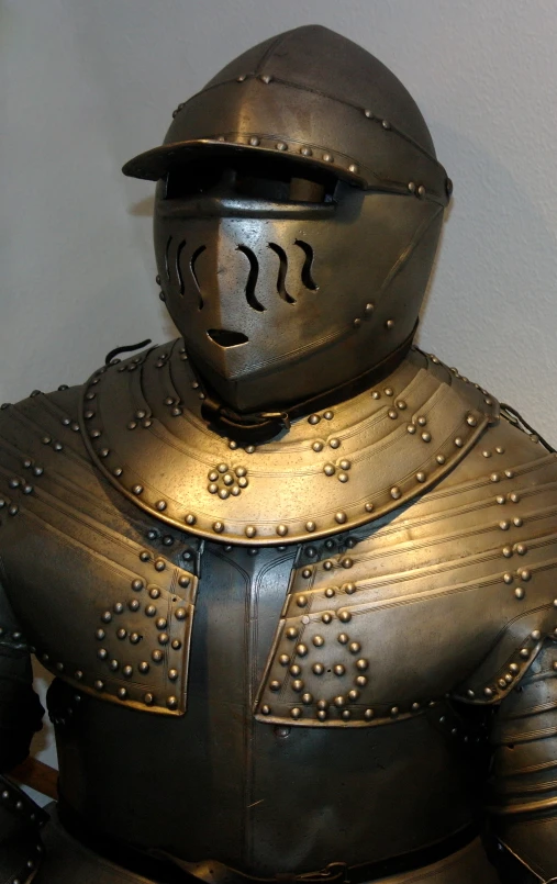 an old knight costume and helmet for the man to play the role of in medieval knights