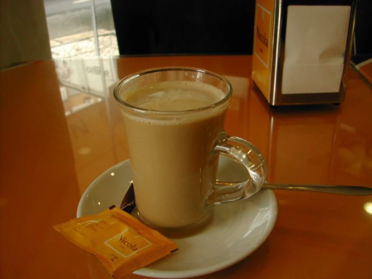 a glass on top of a table holding beverage