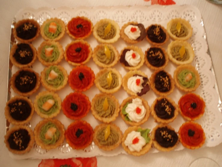 small assortment of decorated cookies with a doily