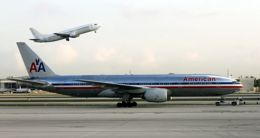 an american airlines airplane is flying over the ground