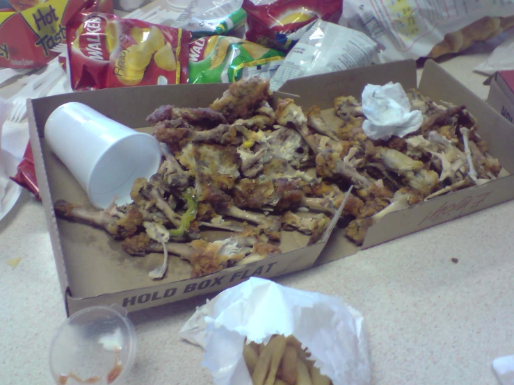 a box of food containing fried food sits on the counter