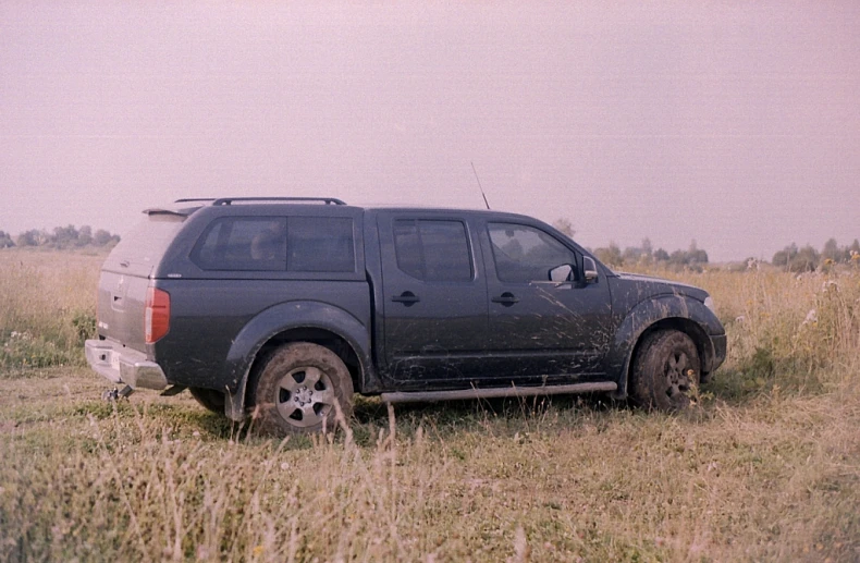 a vehicle parked in a grassy field on the grass