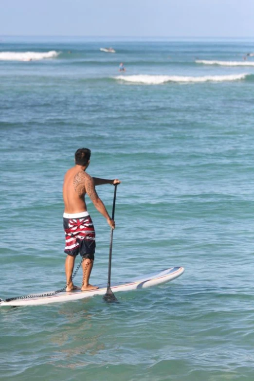 a man with  on riding a surfboard