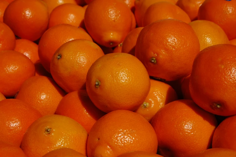 oranges are piled up in close to each other