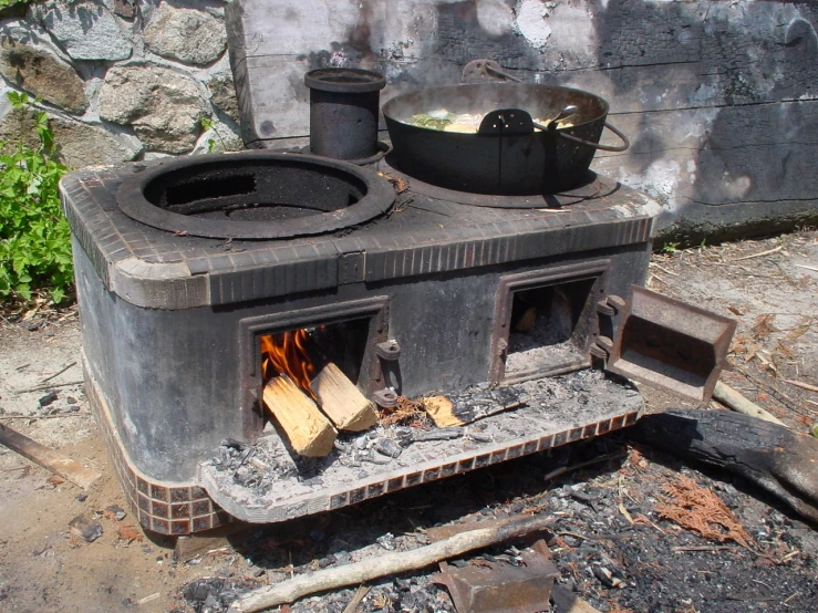 an old stove with some pots and pans on it