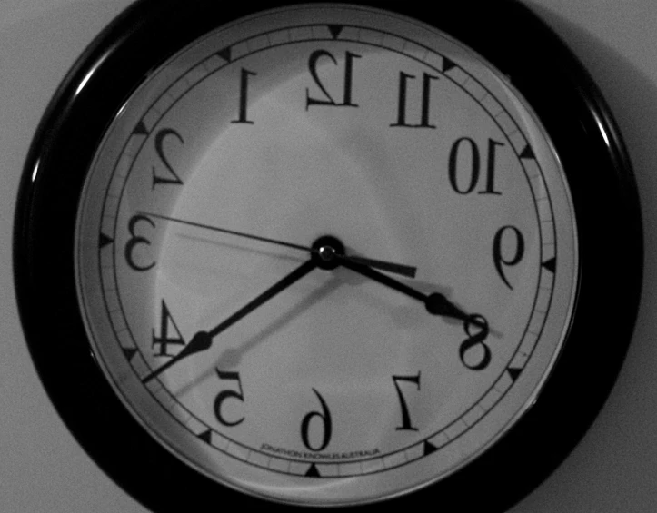 a clock on the wall shows 11 05 with two hands