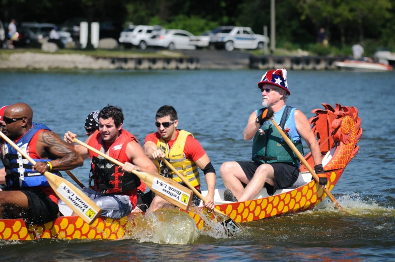 some people are rowing in a dragon boat