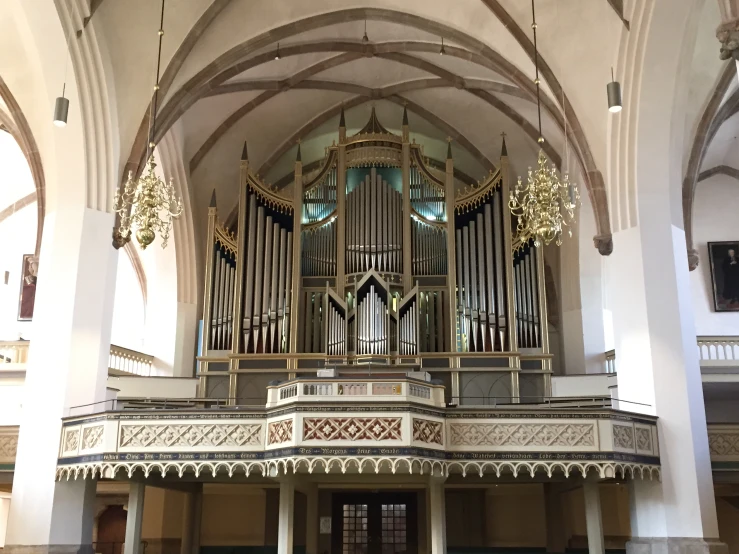 a large pipe organ on display in an old building