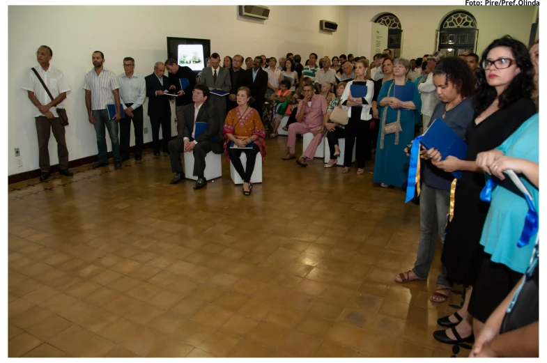 a woman walking on a dance floor while people watch her