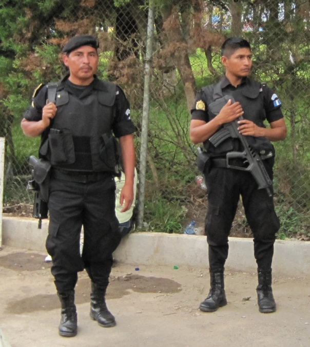 two policemen walking in front of a guard dog