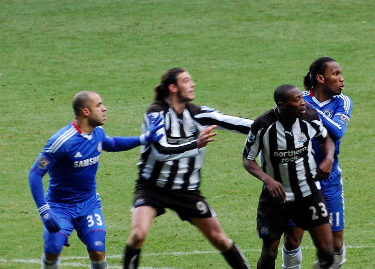 players from two teams of soccer team fighting for the ball