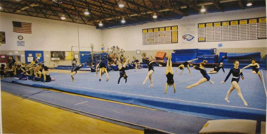 two teams of people perform a routine on a trampoline
