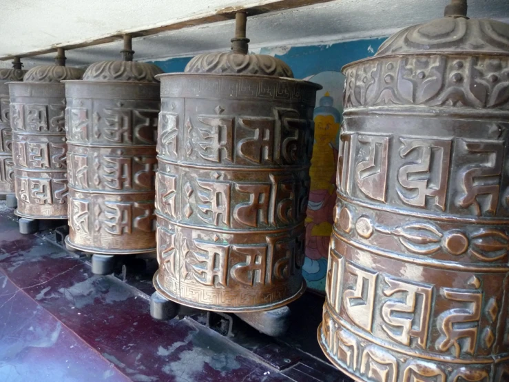 several very large ornate bell on a stand