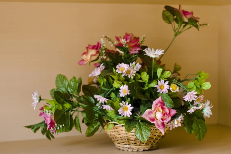 small basket full of various color flowers