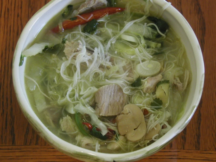 a close up view of a bowl of noodles, vegetables and noodles